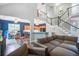 Open-concept living room features hardwood floors, staircase, and seamless flow to the kitchen and dining area at 113 Ashton Cv, Summerville, SC 29485