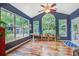 Bright sunroom with large windows, a ceiling fan, and beautiful wood floors at 113 Ashton Cv, Summerville, SC 29485