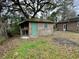 Side view of a brick shed with a mossy roof and a small screened area at 113 Germantown Rd, Summerville, SC 29483