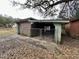 Exterior view of a brick shed with a covered enclosure and chain-link gates at 113 Germantown Rd, Summerville, SC 29483