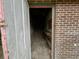 View from the doorway into an empty brick shed with a small work bench at 113 Germantown Rd, Summerville, SC 29483