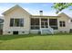 View of the home's backyard and screened porch with white railings and grassy lawn at 1150 Quick Rabbit Loop, Charleston, SC 29414