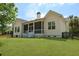 Spacious backyard featuring a screened porch with steps leading down to a well-maintained lawn at 1150 Quick Rabbit Loop, Charleston, SC 29414