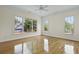 Airy bedroom with hardwood floors, crown molding, and large windows overlooking the landscape at 1150 Quick Rabbit Loop, Charleston, SC 29414