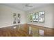 Bright bedroom features hardwood floors, double doors, and a large window, offering scenic views at 1150 Quick Rabbit Loop, Charleston, SC 29414