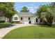Inviting home featuring a manicured lawn, welcoming front porch, and an attached garage at 1150 Quick Rabbit Loop, Charleston, SC 29414