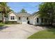 Charming home with a well-manicured lawn and a front porch with white columns and railings at 1150 Quick Rabbit Loop, Charleston, SC 29414