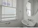 Charming powder room featuring a pedestal sink and window with blinds for natural light at 1150 Quick Rabbit Loop, Charleston, SC 29414