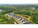 An aerial view of a community of homes near a pond, surrounded by a lush forest at 117 Osprey Ridge Ln, Summerville, SC 29483