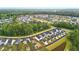 Expansive aerial view of a thriving neighborhood surrounded by green trees and a serene pond at 117 Osprey Ridge Ln, Summerville, SC 29483