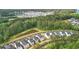 Aerial view of neighborhood with a pond and lush greenery, showcasing modern home designs and community at 117 Osprey Ridge Ln, Summerville, SC 29483
