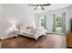 Relaxing bedroom featuring a comfortable queen bed, hardwood floors, and natural light at 117 Osprey Ridge Ln, Summerville, SC 29483