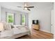 Comfortable bedroom with a queen bed, ceiling fan, hardwood floors, and natural light at 117 Osprey Ridge Ln, Summerville, SC 29483