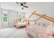 Charming bedroom with two twin beds, ceiling fan, and ample natural light at 117 Osprey Ridge Ln, Summerville, SC 29483