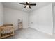 Bright bedroom with a ceiling fan, closet, and a wooden crib with toys on a shelf at 117 Osprey Ridge Ln, Summerville, SC 29483