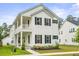 Charming two-story home with a spacious porch and manicured landscaping at 117 Osprey Ridge Ln, Summerville, SC 29483