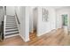 Inviting hallway with hardwood floors, staircase, and convenient half bath at 117 Osprey Ridge Ln, Summerville, SC 29483