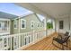 Relaxing porch with wooden floors, white railings, and comfortable seating at 117 Osprey Ridge Ln, Summerville, SC 29483