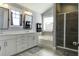 Bright bathroom features dual sinks, large soaking tub, and glass-enclosed shower at 1209 Hammrick Ln, Johns Island, SC 29455