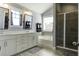 Bathroom with double vanity, soaking tub, glass-enclosed shower, and stylish fixtures at 1209 Hammrick Ln, Johns Island, SC 29455
