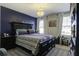 Bedroom with a large bed, dark blue accent wall, bedside tables, and a chandelier at 1209 Hammrick Ln, Johns Island, SC 29455