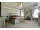 Spacious bedroom with a large bed, sitting area, tray ceiling, and modern furnishings at 1209 Hammrick Ln, Johns Island, SC 29455