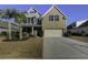 Attractive two-story home with brick and siding, palm trees, and a well-manicured lawn at 1209 Hammrick Ln, Johns Island, SC 29455