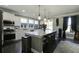 Modern kitchen features stainless steel appliances, a large island, and stylish pendant lighting at 1209 Hammrick Ln, Johns Island, SC 29455
