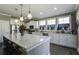 Bright kitchen with white cabinets, stainless steel appliances, and a spacious center island at 1209 Hammrick Ln, Johns Island, SC 29455