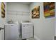 Well-lit laundry room with shelving and a modern washer and dryer set at 1209 Hammrick Ln, Johns Island, SC 29455