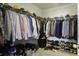 Organized walk-in closet with hanging clothes, shelves for shoes, and storage containers at 1209 Hammrick Ln, Johns Island, SC 29455
