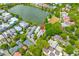 Aerial view showcases the house with a lake nearby surrounded by lush trees at 121 W Shipyard Rd, Mount Pleasant, SC 29464