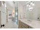 Bright bathroom features a glass shower, neutral tiling, and double sink vanity with ample lighting at 121 W Shipyard Rd, Mount Pleasant, SC 29464