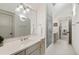 Spacious bathroom with large mirror, glass shower, double sink vanity, and neutral colored tiling at 121 W Shipyard Rd, Mount Pleasant, SC 29464