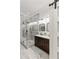 Bright bathroom with a glass enclosed shower, marble floors, and a wooden vanity with double sinks at 121 W Shipyard Rd, Mount Pleasant, SC 29464