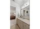 A well-lit bathroom with a neutral vanity, a large mirror, and a glimpse into the Primary bedroom at 121 W Shipyard Rd, Mount Pleasant, SC 29464