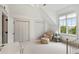 Bright bedroom with white carpet, furniture, and walls has a large window with an outside view at 121 W Shipyard Rd, Mount Pleasant, SC 29464