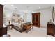 Bright bedroom featuring a bed with decorative pillows and a large wardrobe, complemented by natural light from the windows at 121 W Shipyard Rd, Mount Pleasant, SC 29464