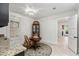 A well-lit dining area with a round table and dark wooden china cabinet with a view into the entry and stairs at 121 W Shipyard Rd, Mount Pleasant, SC 29464