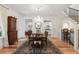 Elegant dining room featuring hardwood floors, chandelier, staircase, and wainscoting at 121 W Shipyard Rd, Mount Pleasant, SC 29464