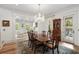Formal dining room features a chandelier, wood floors, and access to the living room at 121 W Shipyard Rd, Mount Pleasant, SC 29464