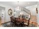 Dining room showcases a chandelier, wood floors, and view of staircase at 121 W Shipyard Rd, Mount Pleasant, SC 29464