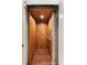 Interior elevator with paneled wood walls, hardwood floor, and folding safety door at 121 W Shipyard Rd, Mount Pleasant, SC 29464