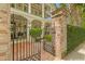 Gated brick entrance with lush green hedge and wrought-iron gate to a beautiful home at 121 W Shipyard Rd, Mount Pleasant, SC 29464