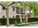Exterior of a home with a second-story balcony, gated entrance, and manicured landscaping at 121 W Shipyard Rd, Mount Pleasant, SC 29464