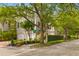 Exterior view of a charming home with lush landscaping and mature trees at 121 W Shipyard Rd, Mount Pleasant, SC 29464