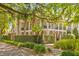 Stately two-story home with a double porch and wrought iron railings, enhanced by mature trees and landscaping at 121 W Shipyard Rd, Mount Pleasant, SC 29464
