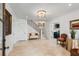 An inviting foyer with neutral tile flooring, a staircase, a fancy chandelier, and decorative furnishings at 121 W Shipyard Rd, Mount Pleasant, SC 29464