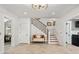 Bright foyer featuring a staircase with wrought iron railings, tiled floor, and elegant trim at 121 W Shipyard Rd, Mount Pleasant, SC 29464