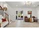 Elegant foyer with decorative light fixture, hardwood staircase, and formal seating area at 121 W Shipyard Rd, Mount Pleasant, SC 29464